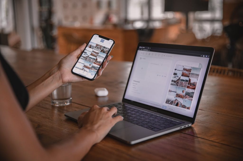 woman using a phone and laptop